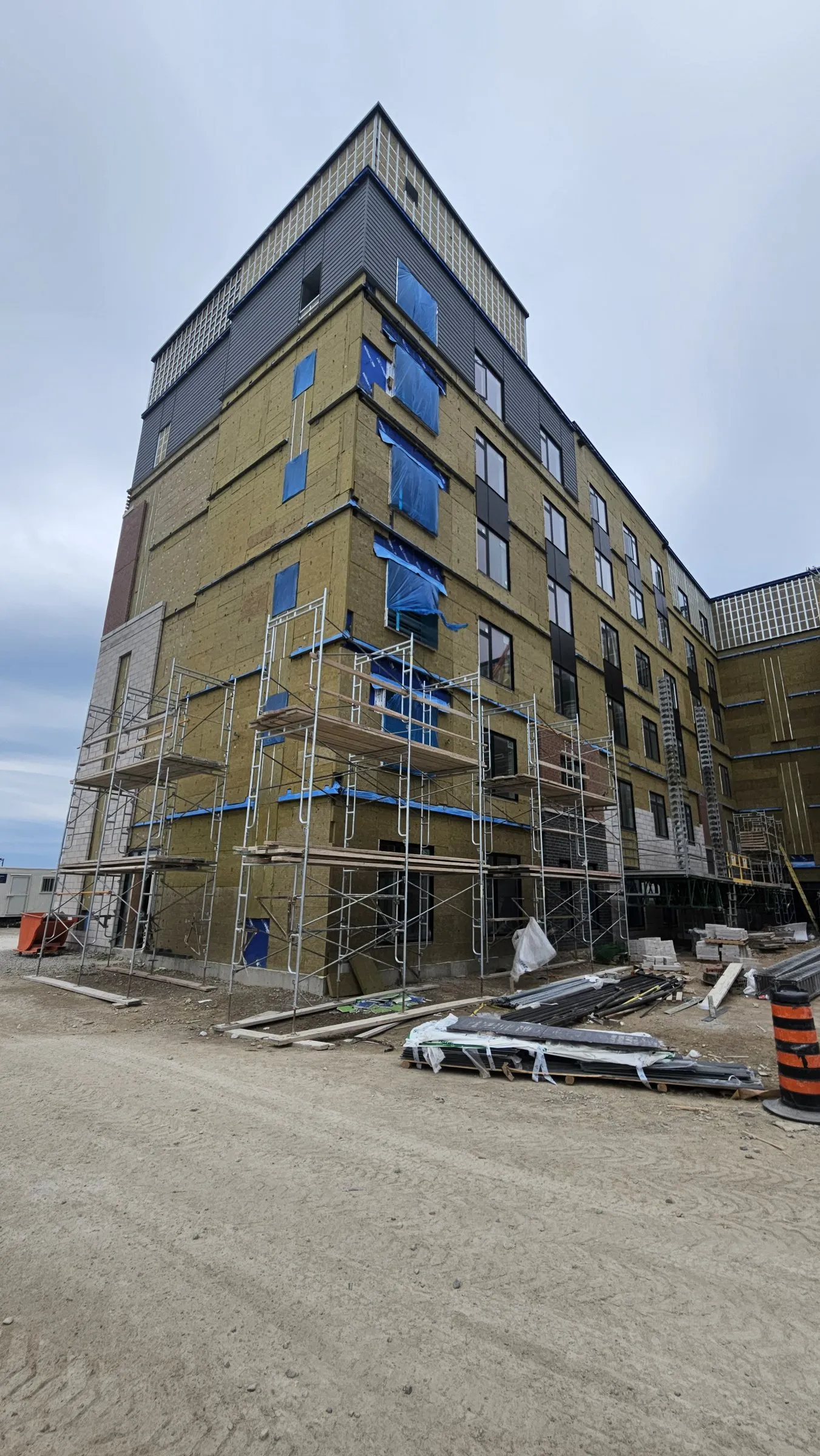 Mid-rise residential building with exterior insulation and scaffolding