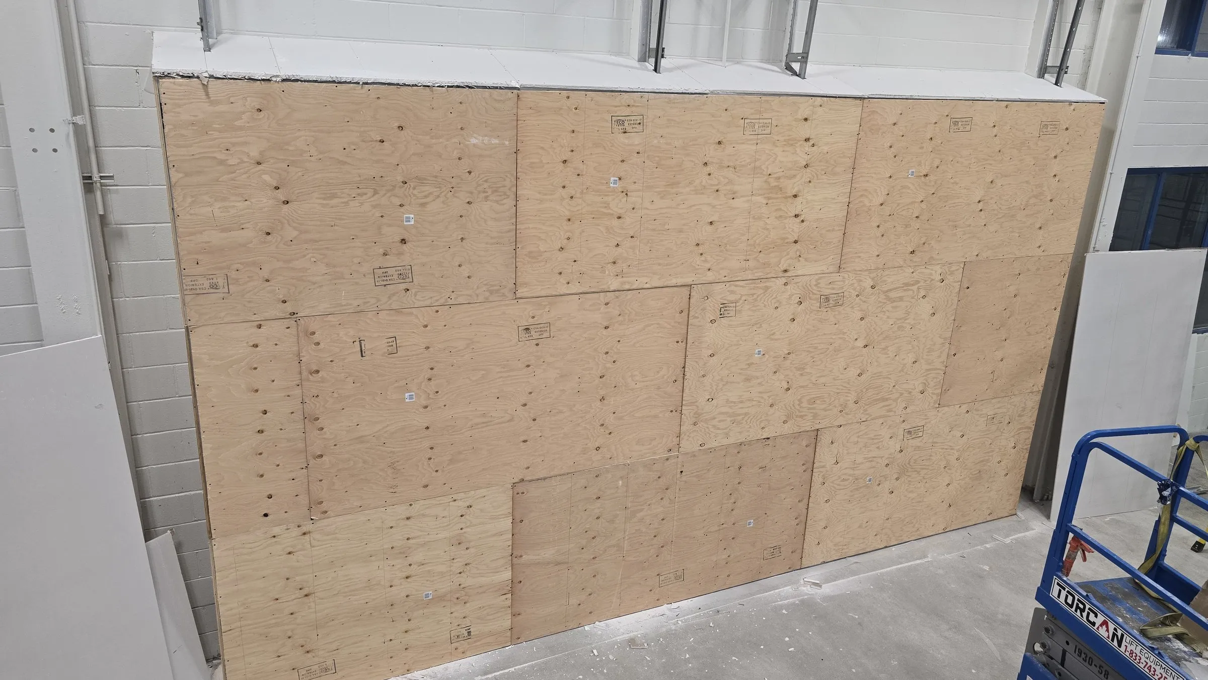 Plywood sheathing fastened across the new wall