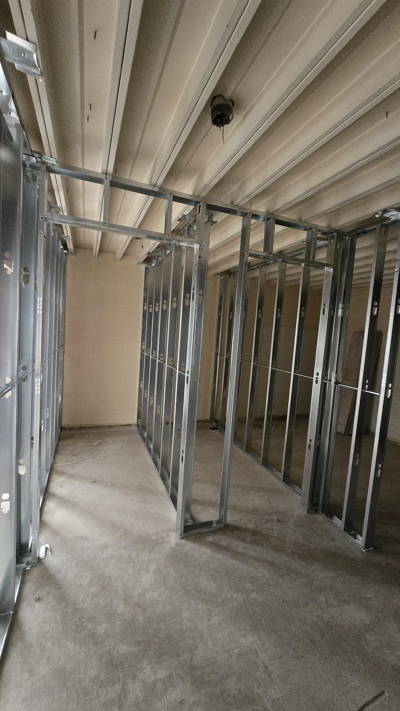 Steel stud partitions with door openings framed under an existing ceiling
