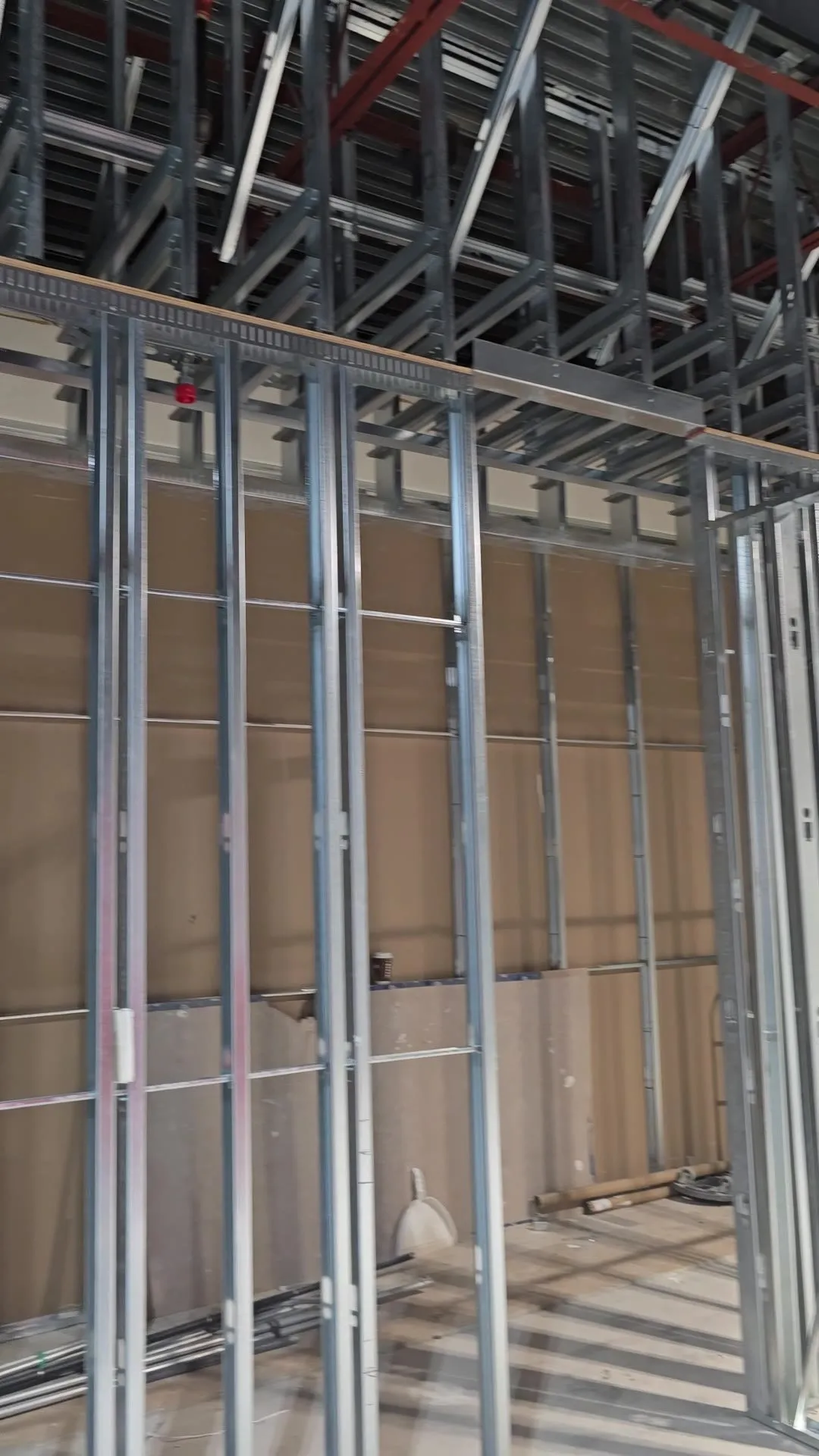 Video of full-height steel stud partitions and a steel-framed ceiling bulkhead along a corridor