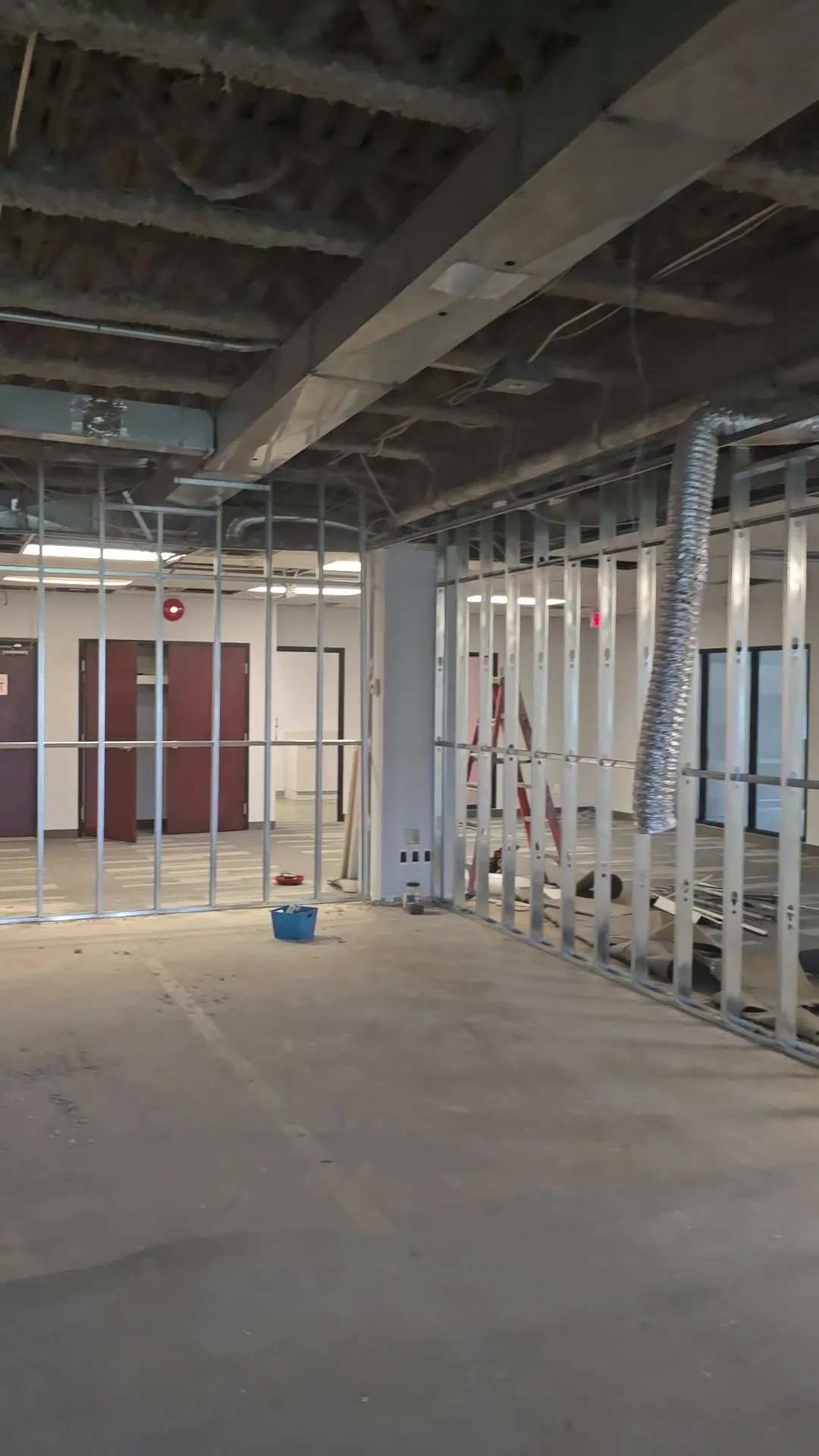 Video of new steel stud partitions on an office floor, then the same walls boarded