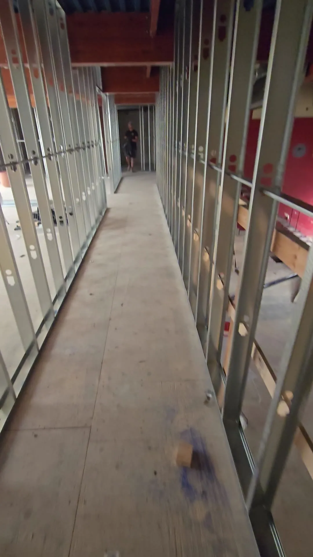 Walk-through video along new steel stud corridor walls and framed rooms